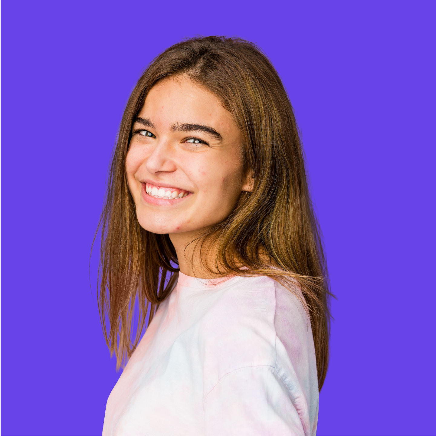 Older female teen with visible acne confidently smiling.