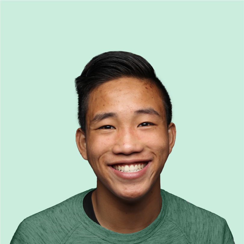 Older male teen with visible acne confidently smiling at camera.